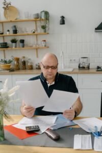 Canadian homeowner reviewing mortgage renewal documents with a concerned expression