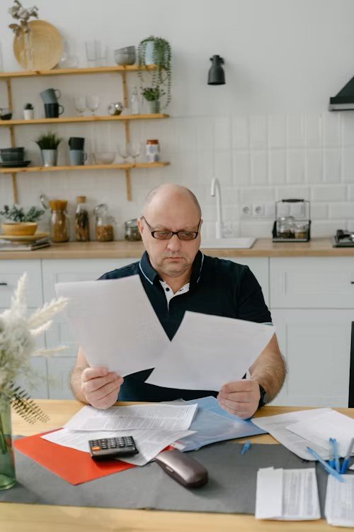 Canadian homeowner reviewing mortgage renewal documents with a concerned expression