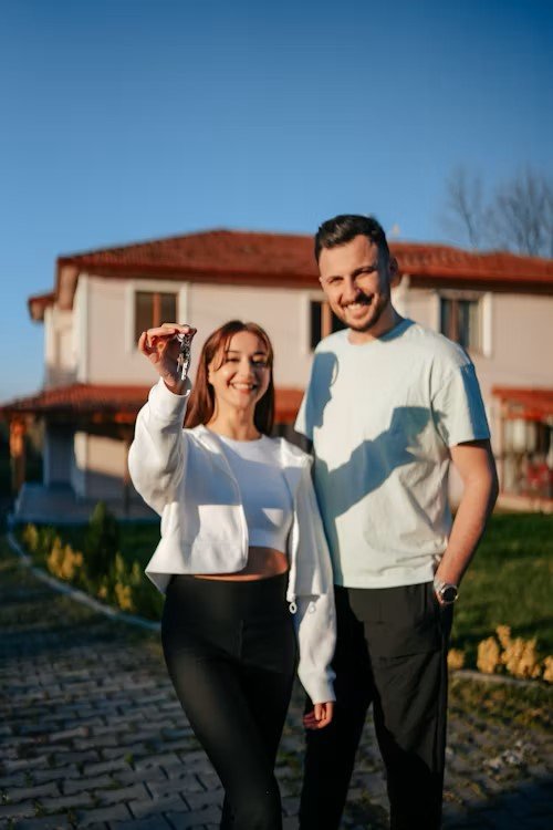 Young Canadian couple calculating how much home they can afford in 2025 with housing market uncertainty