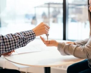 Canadian couple exchanging house keys, representing mortgage transfer or assumption