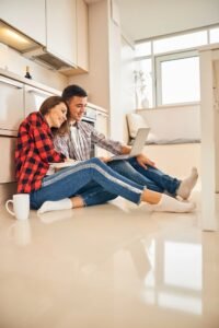 Canadian couple reviewing mortgage options on laptop, deciding whether to switch providers