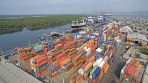 Shipping containers at port with construction materials, symbolizing impact of Asian supply chain disruptions on Canadian building sector