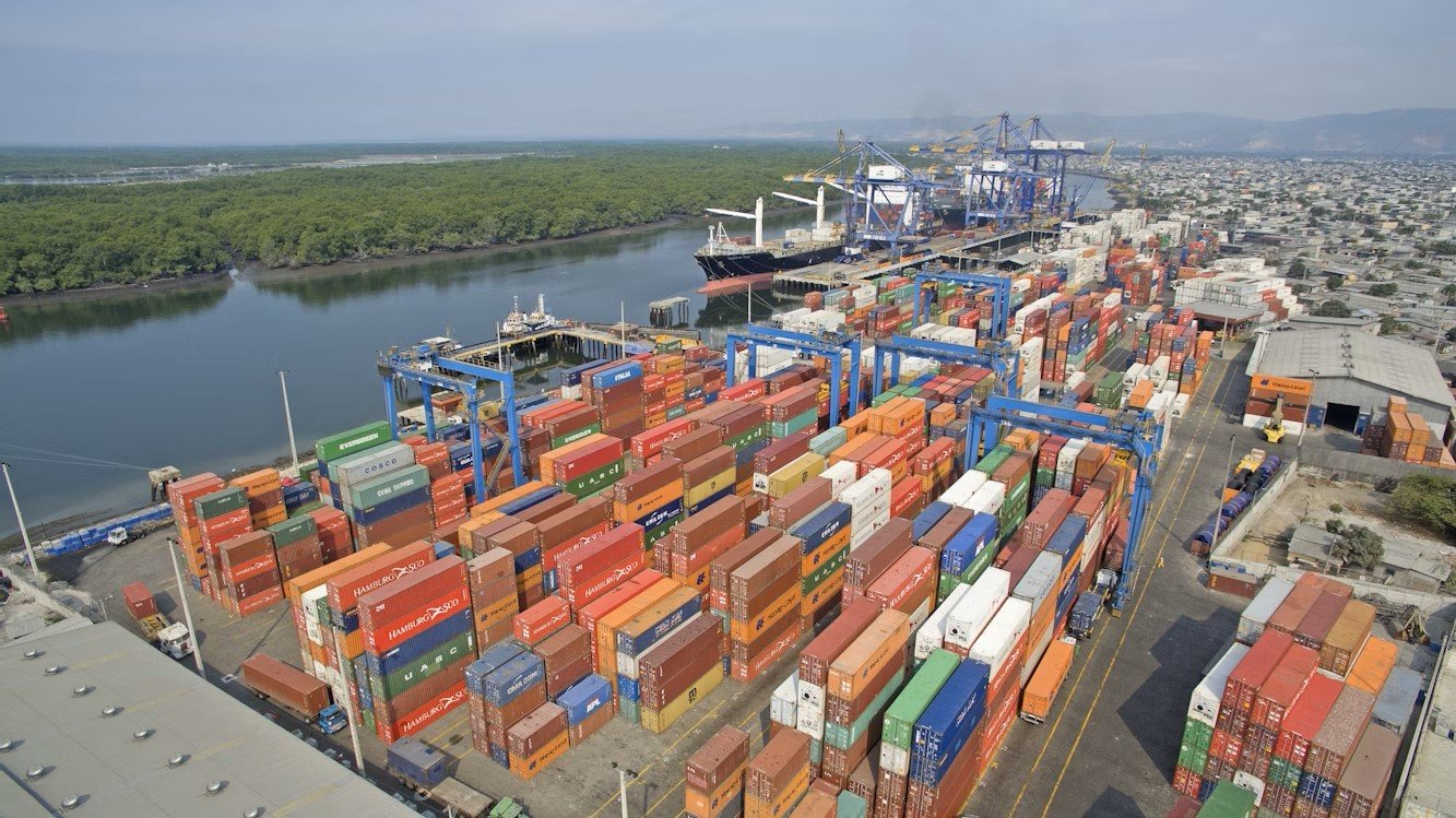Shipping containers at port with construction materials, symbolizing impact of Asian supply chain disruptions on Canadian building sector
