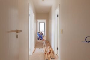 Canadian homeowner reviewing renovation budget with rising prices in background