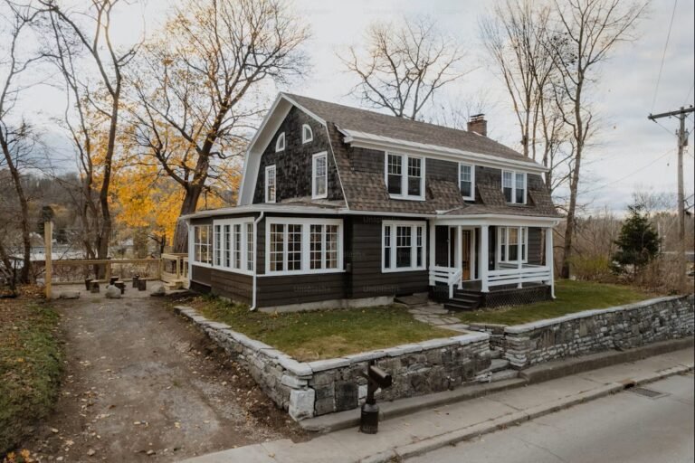Foreclosed house in Canada with a warning sign on the lawn and a vacant look