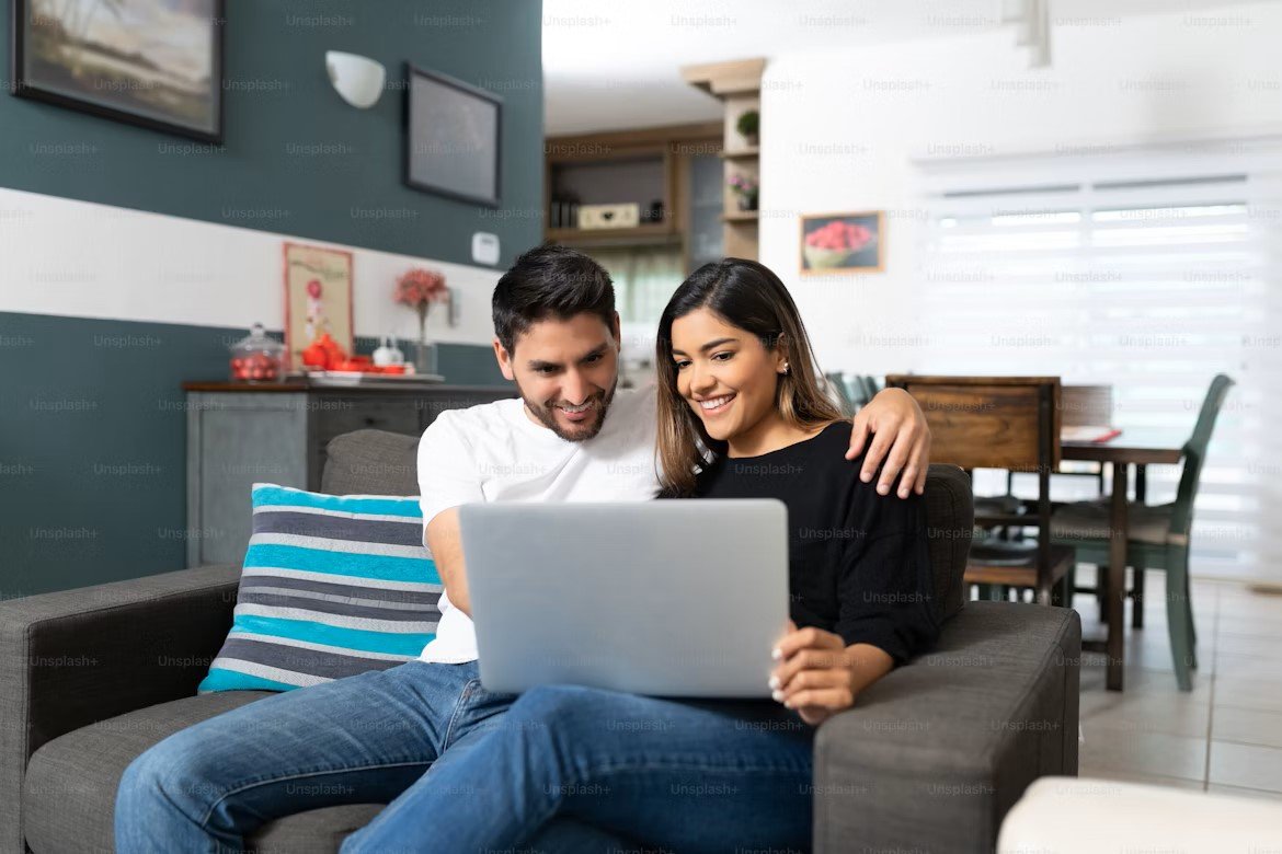 Canadian couple reviewing 5-year mortgage rate offers online
