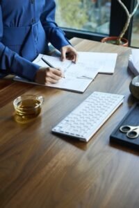 "A Canadian couple at their kitchen table reviewing mortgage documents labeled fixed, variable, and hybrid, with a laptop showing interest rate charts.